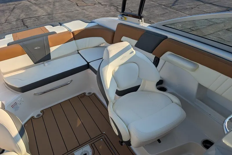 Slide: The Image of 2023 Chaparral 23 SSi boat interior with white and tan seating. - 18