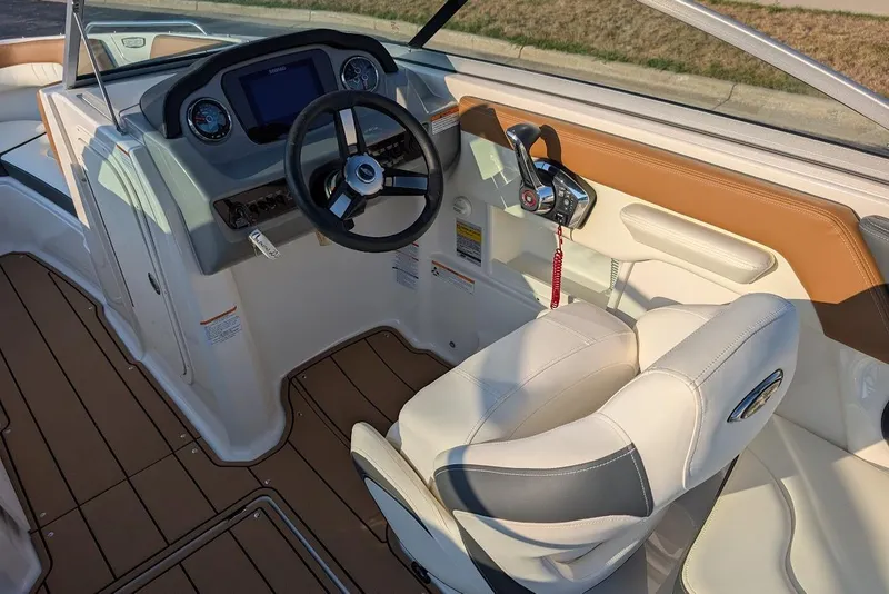 Slide: The Image of 2023 Chaparral 23 SSi boat interior with steering wheel and dashboard controls. - 19