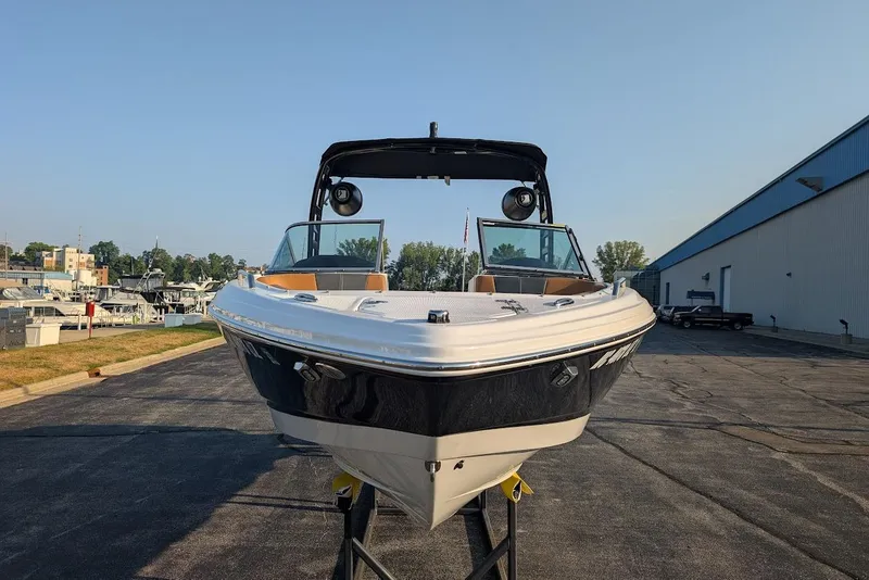 Slide: The Image of 2023 Chaparral 23 SSi boat displayed outdoors on a sunny day. - 2