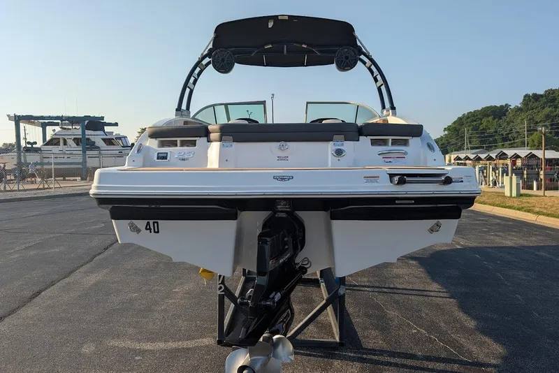 Slide: The Image of 2023 Chaparral 23 SSi boat rear view at marina, showcasing sleek design. - 6