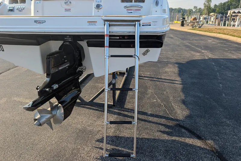 Slide: The Image of 2023 Chaparral 23 SSi boat with ladder and MerCruiser engine on display. - 8