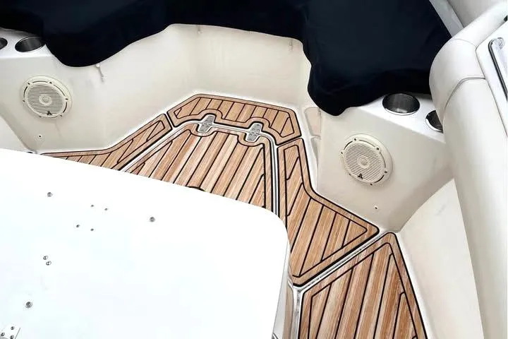 Slide: The Image of 2021 Boston Whaler 250 Outrage interior with teak flooring and built-in speakers. - 11