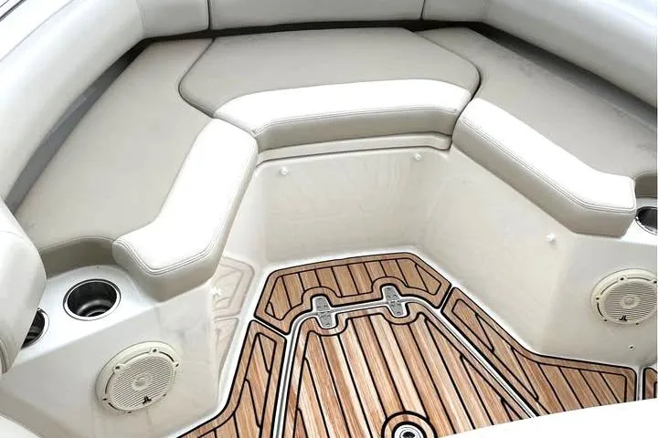 Slide: The Image of 2021 Boston Whaler 250 Outrage boat interior with cushioned seating and teak flooring. - 12
