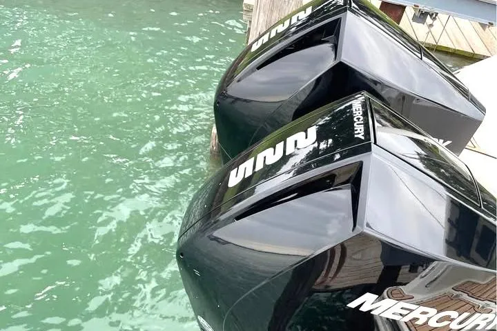 Slide: The Image of Twin Mercury outboard engines on a 2021 Boston Whaler 250 Outrage in clear water. - 13
