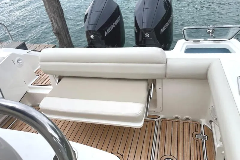 Slide: The Image of 2021 Boston Whaler 250 Outrage boat interior with dual Mercury engines and teak flooring. - 14