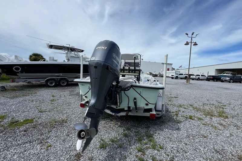 Slide: The Image of 2018 Blazer Bay 2170 boat with Yamaha 200 engine in a gravel lot. - 11