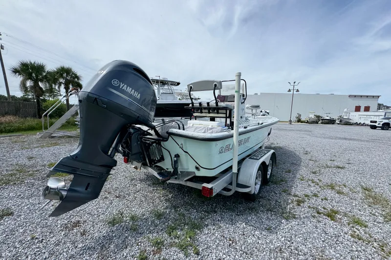 Slide: The Image of 2018 Blazer Bay 2170 boat with Yamaha engine on trailer in gravel lot. - 12
