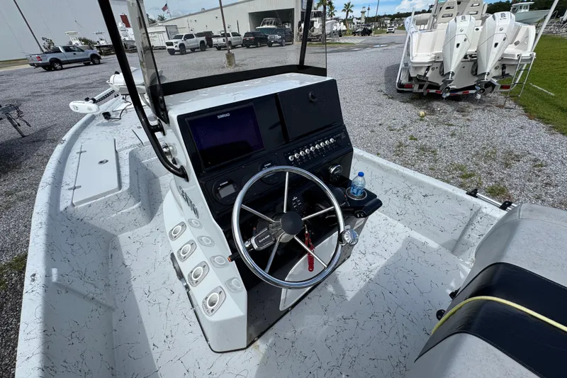 Slide: The Image of 2018 Blazer Bay 2170 boat dashboard with steering wheel and controls. - 24