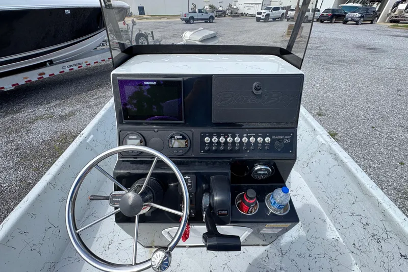 Slide: The Image of 2018 Blazer Bay 2170 boat console with steering wheel, controls, and Simrad display. - 25