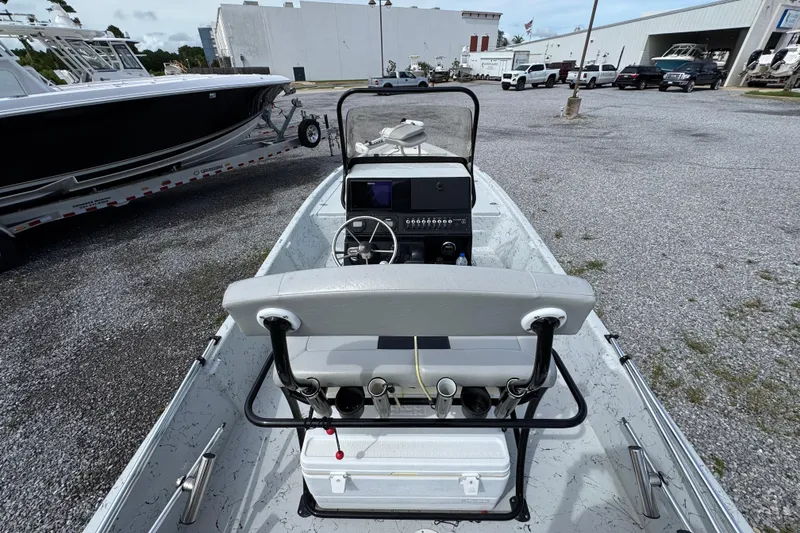 Slide: The Image of 2018 Blazer Bay 2170 boat interior with steering console, parked in a gravel lot. - 27