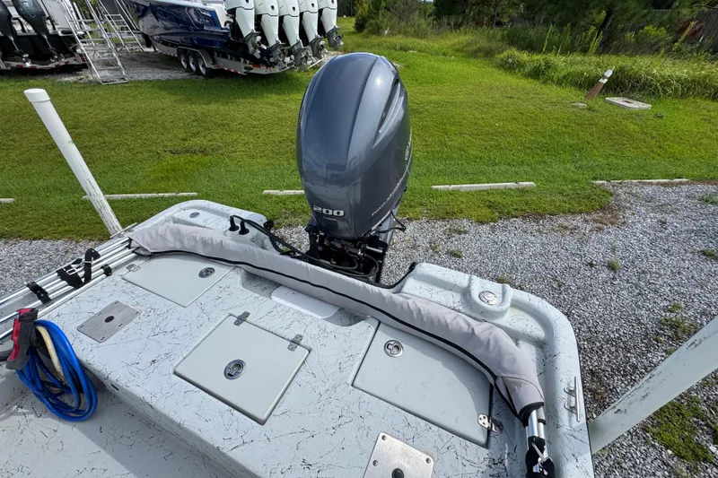 Slide: The Image of 2018 Blazer Bay 2170 boat with outboard motor on grassy area. - 28