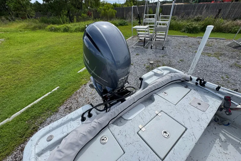 Slide: The Image of 2018 Blazer Bay 2170 boat with Yamaha outboard motor, parked on gravel near grass. - 29