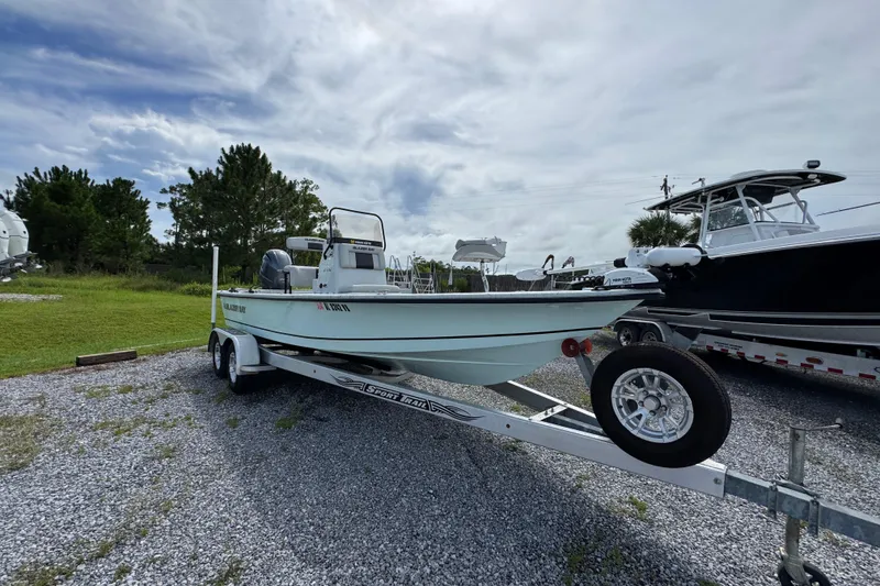 Slide: The Image of 2018 Blazer Bay 2170 boat on trailer, parked outdoors under cloudy sky. - 3