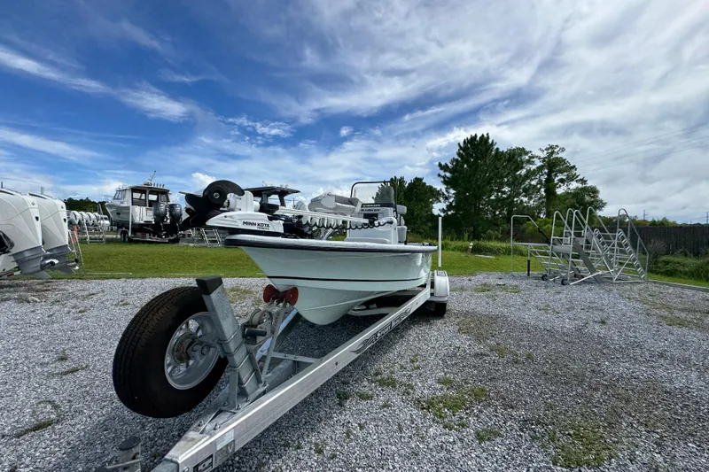 Slide: The Image of 2018 Blazer Bay 2170 boat on trailer under blue sky. - 6