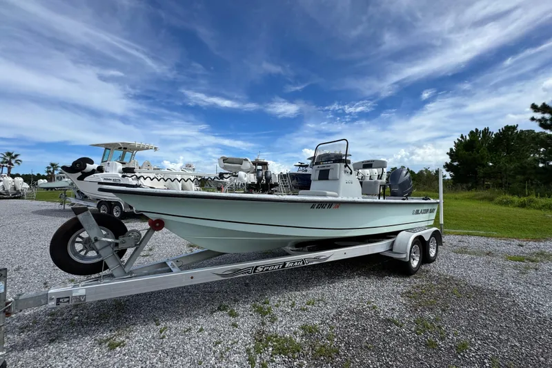 Slide: The Image of 2018 Blazer Bay 2170 boat on trailer under blue sky. - 7