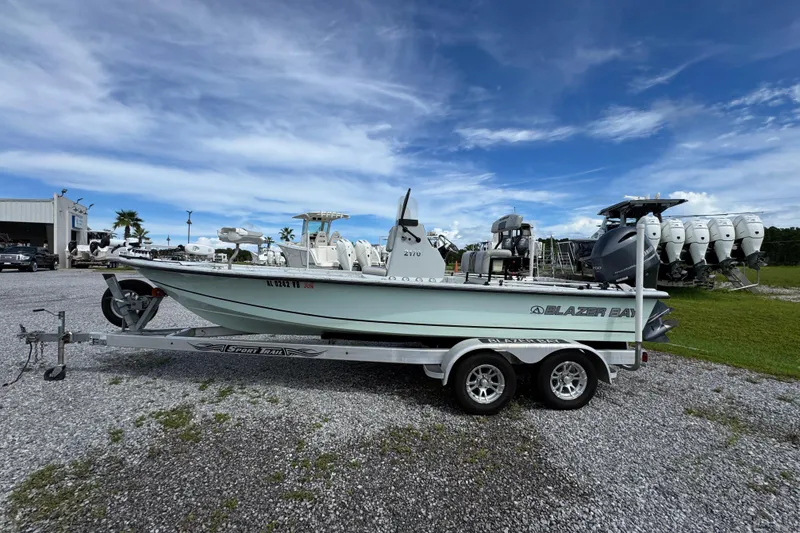 Slide: The Image of 2018 Blazer Bay 2170 boat on trailer under blue sky. - 8