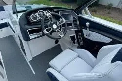 Slide: The Image of 2021 MasterCraft X24 boat interior with luxurious seating and modern dashboard design. - 12