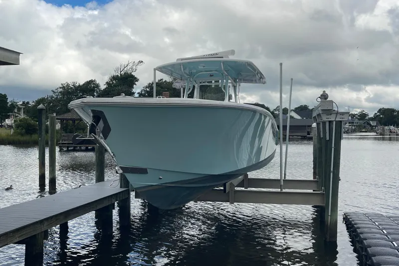Slide: The Image of 2020 Jupiter 38 boat on lift at dock, cloudy sky background. - 10