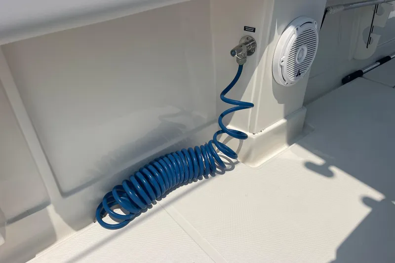 Slide: The Image of Coiled blue hose and speaker on 2020 Jupiter 38 boat deck. - 24