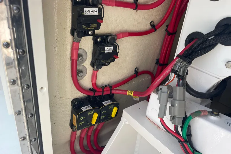 Slide: The Image of Electrical wiring and circuit breakers in a 2020 Jupiter 38 boat. - 28
