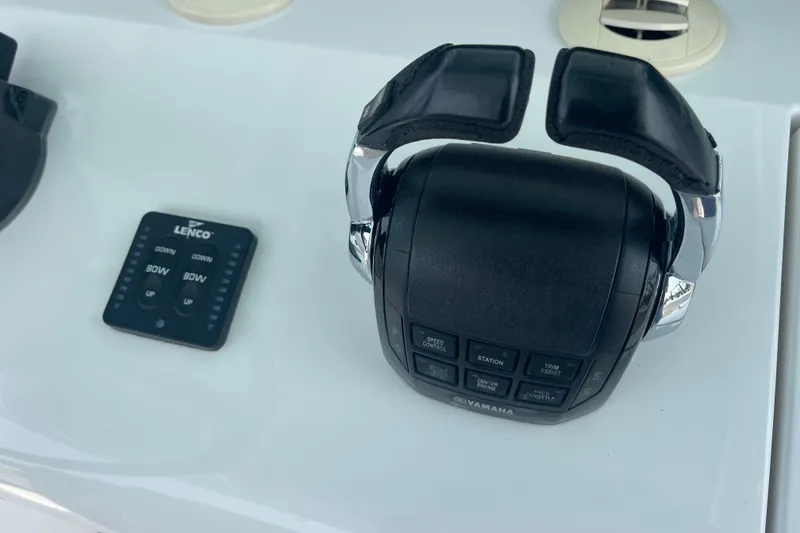 Slide: The Image of Boat throttle controls and Lenco trim tab switch on a 2020 Jupiter 38. - 31