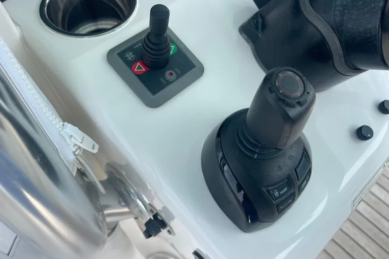 Slide: The Image of Control panel of a 2020 Jupiter 38 boat with joystick and buttons. - 32