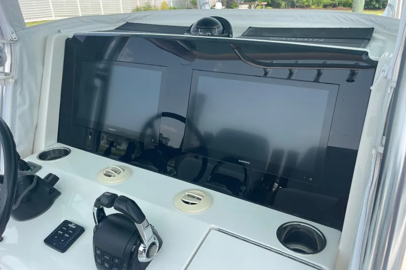Slide: The Image of Jupiter 38 boat dashboard with dual Garmin screens and controls, 2020 model. - 36