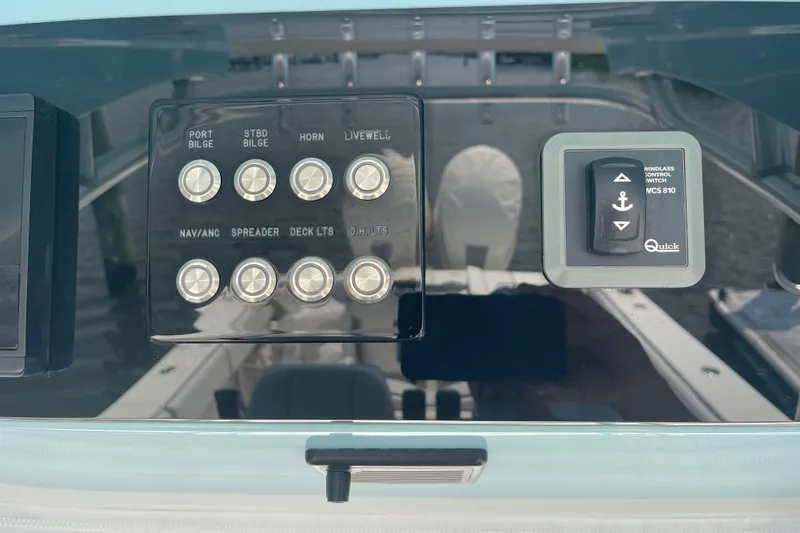 Slide: The Image of Control panel of a 2020 Jupiter 38 boat with various switches and windlass control. - 38