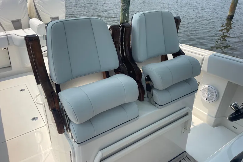 Slide: The Image of 2020 Jupiter 38 boat with luxurious dual helm seats, docked by the water. - 41