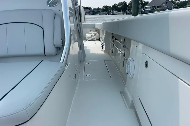 Slide: The Image of 2020 Jupiter 38 boat interior with white seating and storage compartments. - 53