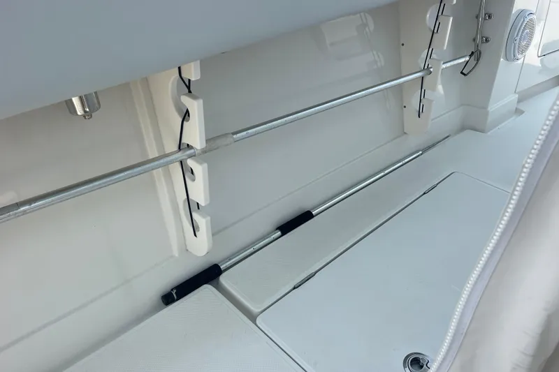 Slide: The Image of Interior view of a 2020 Jupiter 38 boat, showcasing rod holders and storage compartments. - 54