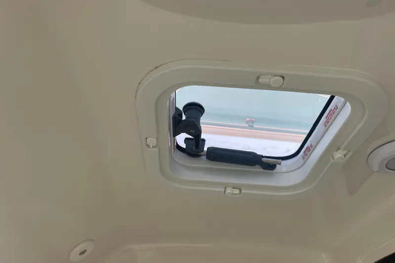 Slide: The Image of Boat hatch interior of 2020 Jupiter 38, showcasing window latch mechanism. - 66