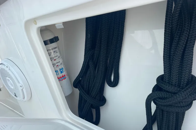 Slide: The Image of Storage compartment on a 2020 Jupiter 38 boat with ropes and a fire extinguisher. - 67