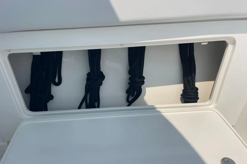 Slide: The Image of Storage compartment with neatly coiled ropes on a 2020 Jupiter 38 boat. - 69