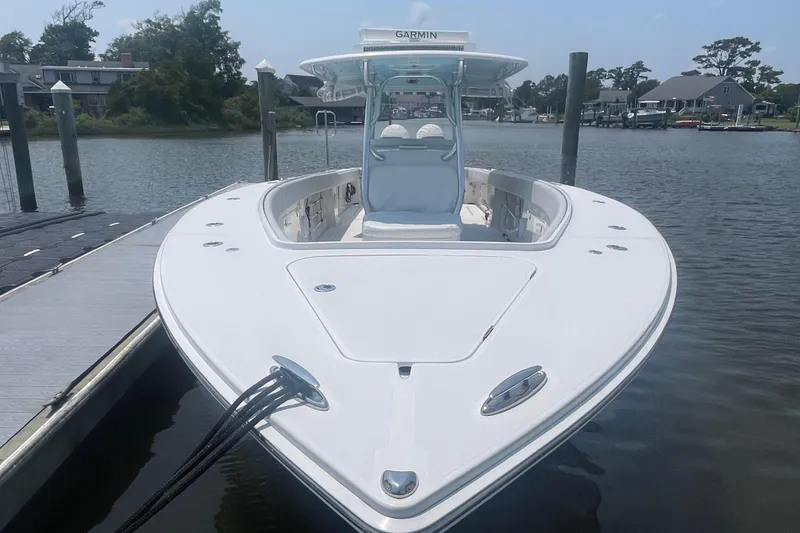 Slide: The Image of 2020 Jupiter 38 boat docked on calm water, featuring sleek design and Garmin equipment. - 7