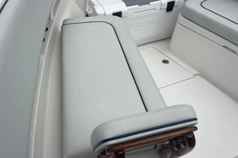 Slide: The Image of 2020 Jupiter 38 boat interior with cushioned seating and Igloo cooler. - 74
