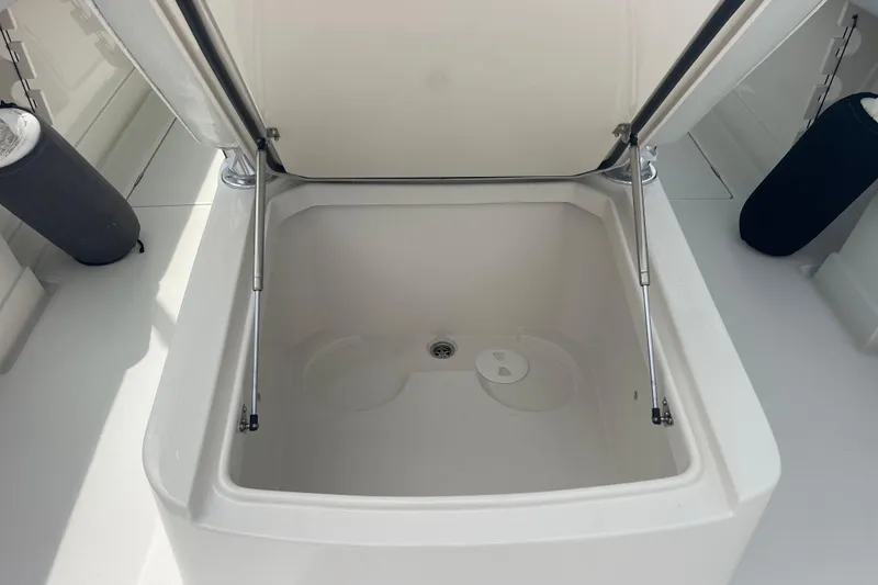 Slide: The Image of Open storage compartment on a 2020 Jupiter 38 boat, featuring hydraulic struts. - 81