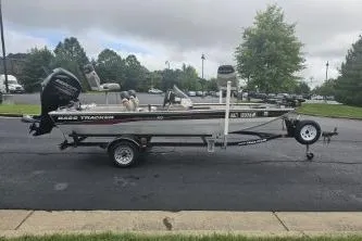 Slide: The Image of 2003 Tracker Pro 165 fishing boat on trailer, parked outdoors. - 3