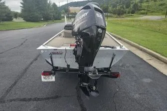 Slide: The Image of 2003 Tracker Pro 165 boat with outboard motor on a paved road. - 4