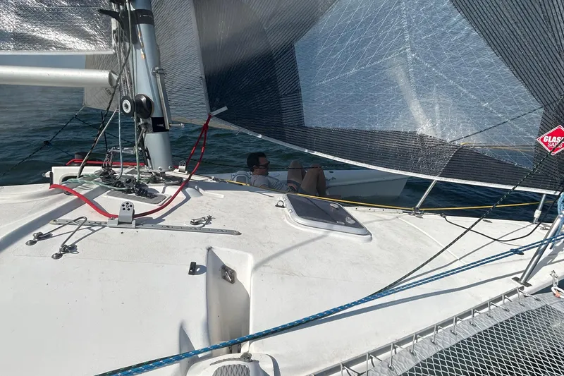 Slide: The Image of 2006 Corsair Sprint 750 sailboat on water, featuring sails and deck details. - 11