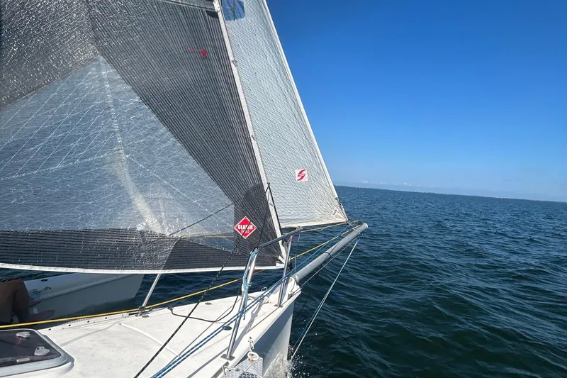 Slide: The Image of Sailing on a 2006 Corsair Sprint 750 trimaran in open waters under clear blue skies. - 12