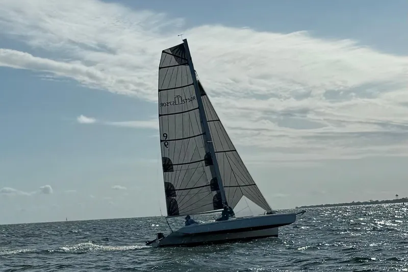 Slide: The Image of Sailing Corsair Sprint 750 trimaran on open water under a cloudy sky, 2006 model. - 20