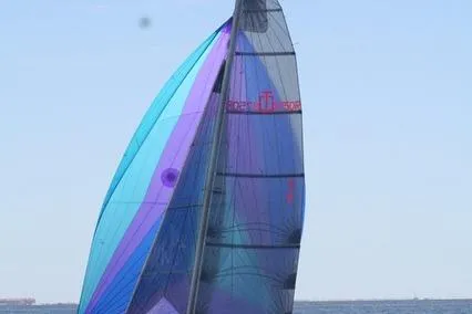Slide: The Image of Corsair Sprint 750 sailboat, 2006 model, with colorful sails on open water. - 5