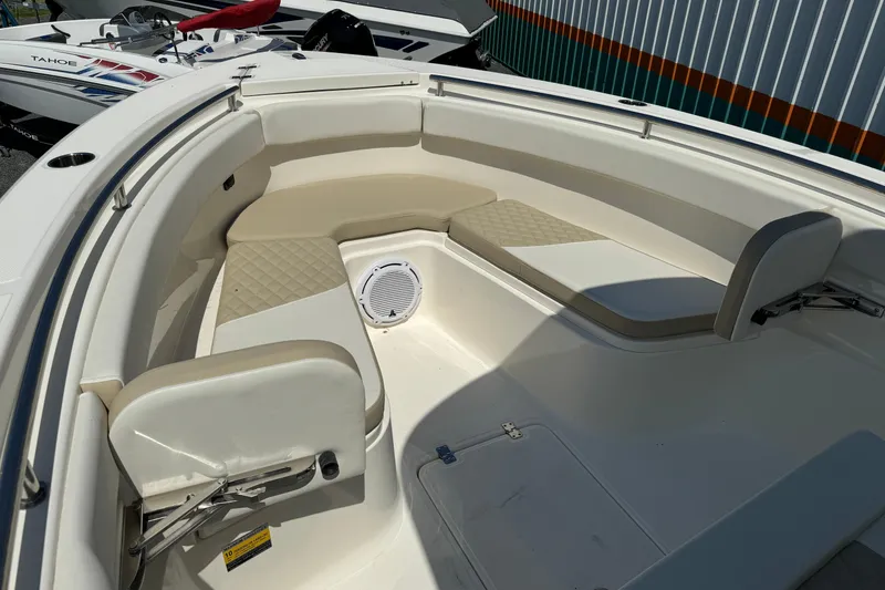 Slide: The Image of 2024 Bulls Bay 255 boat interior with cushioned seating and speaker system. - 10