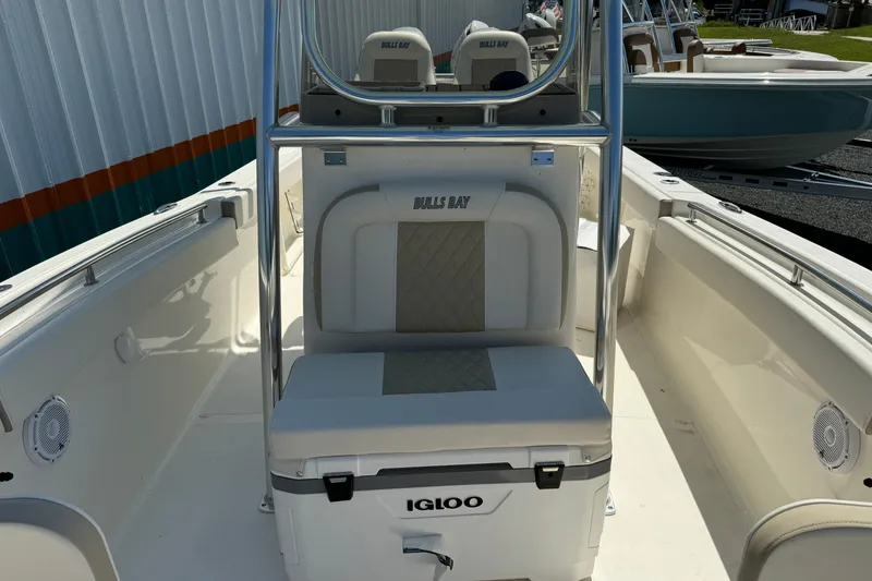 Slide: The Image of 2024 Bulls Bay 255 boat interior with seating and Igloo cooler. - 11