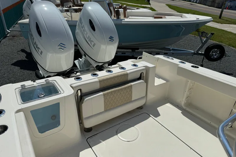 Slide: The Image of 2024 Bulls Bay 255 boat with dual Suzuki outboard engines, featuring a spacious deck layout. - 14