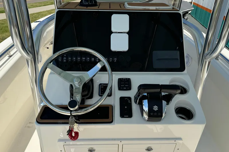 Slide: The Image of 2024 Bulls Bay 255 boat console with steering wheel and controls. - 8