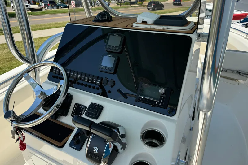 Slide: The Image of 2024 Bulls Bay 255 boat console with steering wheel, controls, and navigation equipment. - 9