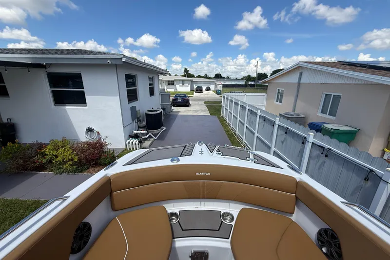 Slide: The Image of 2019 Glastron GTD 220 boat parked in a residential driveway, sunny day. - 24