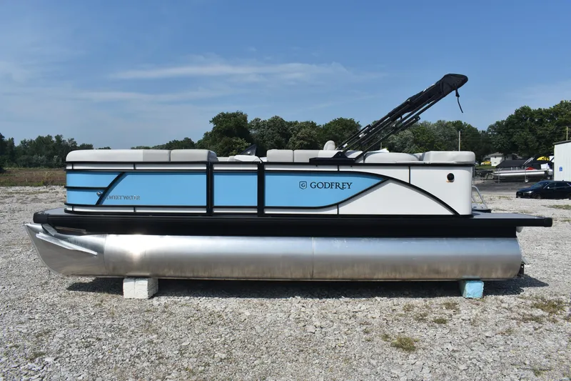 Slide: The Image of 2026 Godfrey SWEETWATER SW 2086 C pontoon boat on gravel lot, side view. - 3